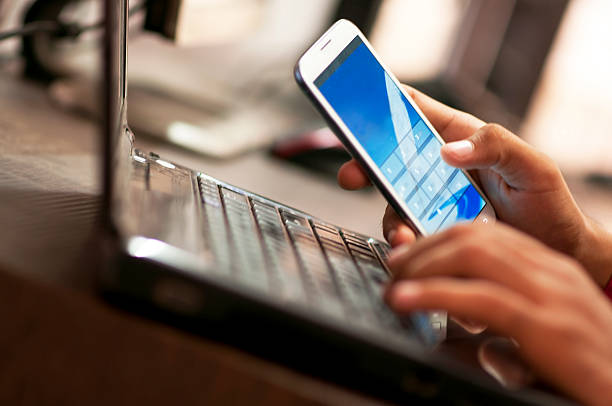 istock Businessman hand using laptop and mobile phone in office 452087681