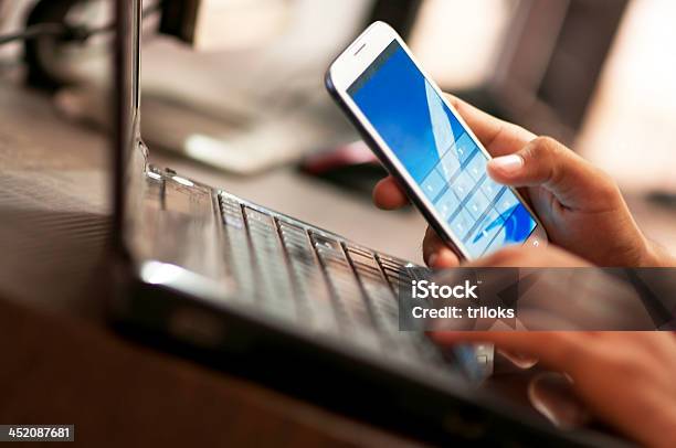 Businessman Hand Using Laptop And Mobile Phone In Office Stock Photo - Download Image Now