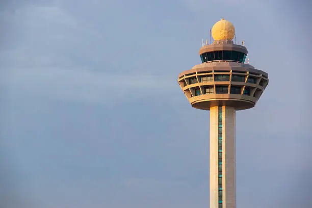 Late afternoon sunlight shines on the air traffic control tower at Changi Airport, Singapore.