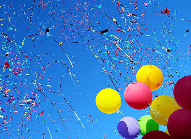 Photo of multicolored balloons and confetti