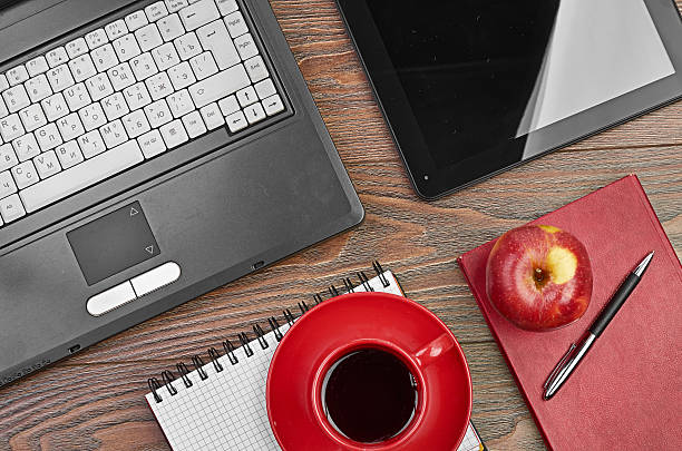 istock Laptop and office supplies on wooden table 452111101