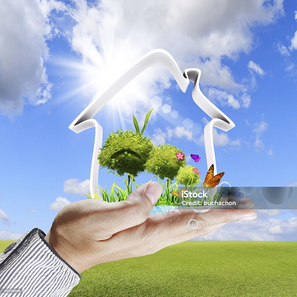 Human hand shows a green house concept Aspirations Stock Photo