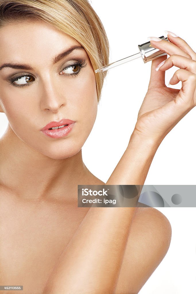 beautiful model applying a skin serum treatment beautiful model applying a skin serum treatment on white Aesthetician Stock Photo