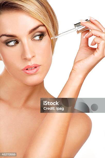Beautiful Model Applying A Skin Serum Treatment Stock Photo - Download Image Now - Aesthetician, Adult, Aging Process