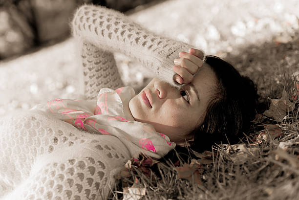istock Woman laying in grass 452126769