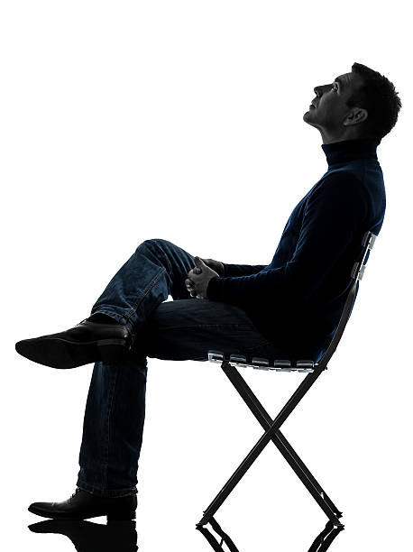 istock man sitting looking up silhouette full length 452143367