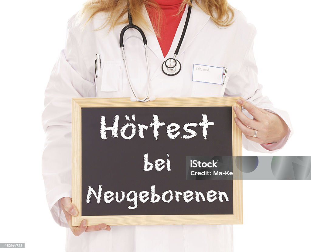 Hearing Test Doctor with shield and the german words Hearing screening for newborns Baby - Human Age Stock Photo