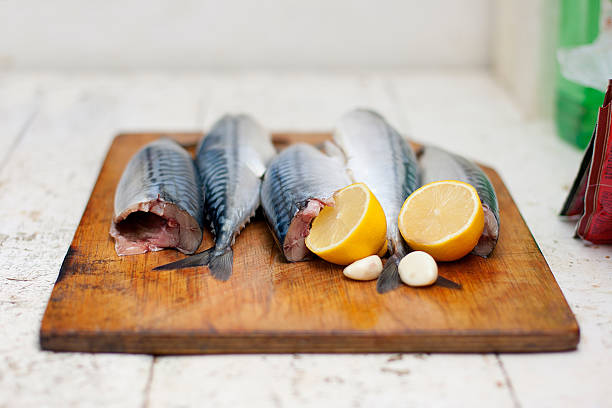 istock Fish carcass with spices on wooden hardboard, prepared for cooki 452145281