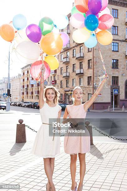 Two Beautiful Ladys In Retro Outfit Holding Balloons Stock Photo - Download Image Now
