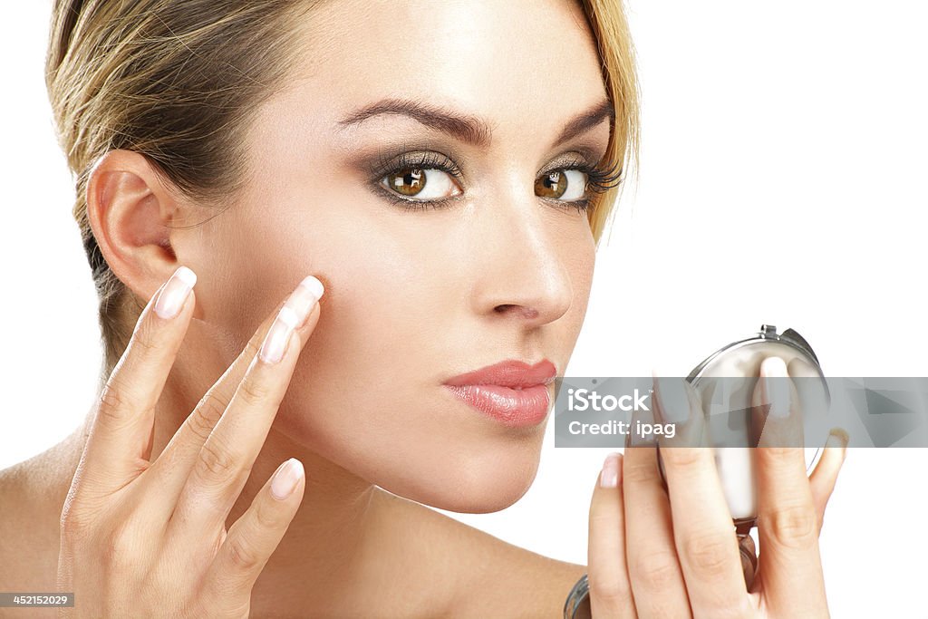 close up of a  young beauty woman with mirror close up of a  of young beauty woman with mirror on white Acne Stock Photo