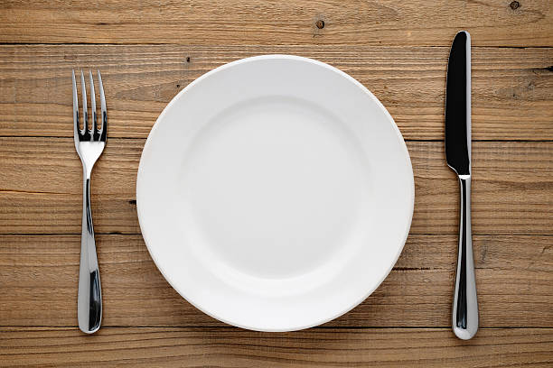 istock Plate, fork and knife on wood 452155623
