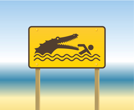 Illustration of a warning alert sign with an alligator and a swimmer.
