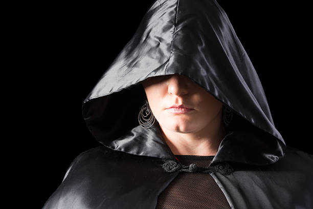 istock Woman in black satin cape, only lower face showing. 452179437