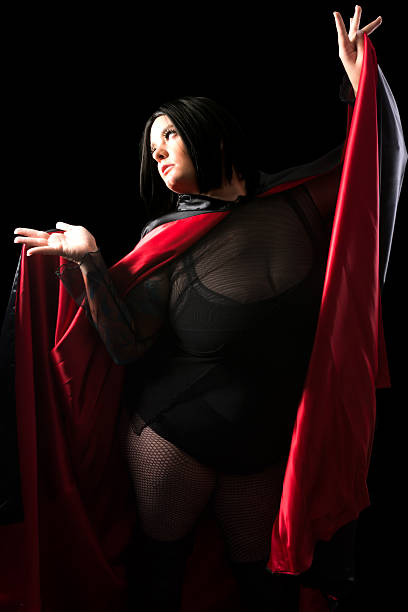 istock Young woman in black mesh and satin cloak. 452179567