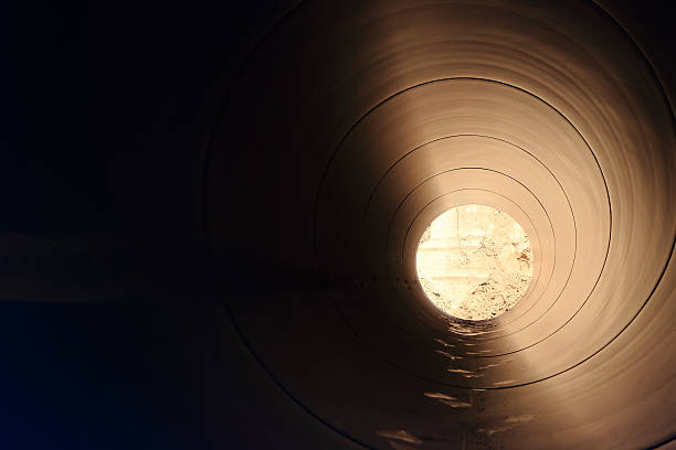 istock Image of long, dark tunnel with a small opening 452190769
