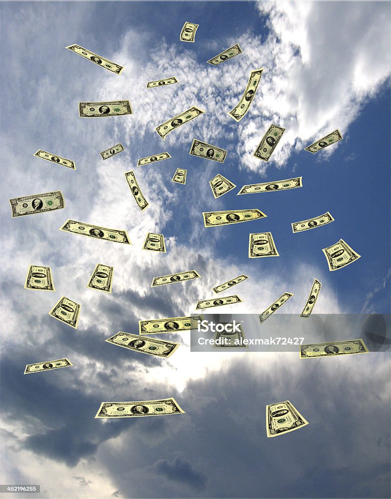 dollar banknotes flying away in the sky dollar banknotes flying away in the blue sky Blue Stock Photo