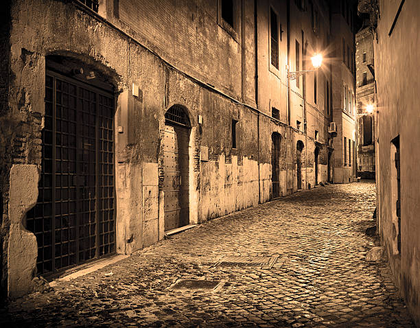 istock Empty alley after rain at night, Rome Italy 452200449