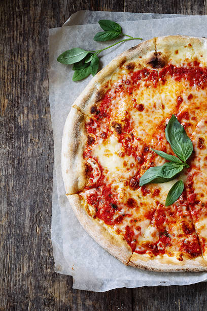 istock Stone baked marguerite pizza with basil garnish 452200617