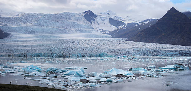 istock Two people in front of giant glacier lake 452204183