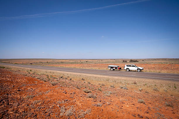 Touring Outback Australia - Four Wheel Drive Towing Camper Trailer stock photo