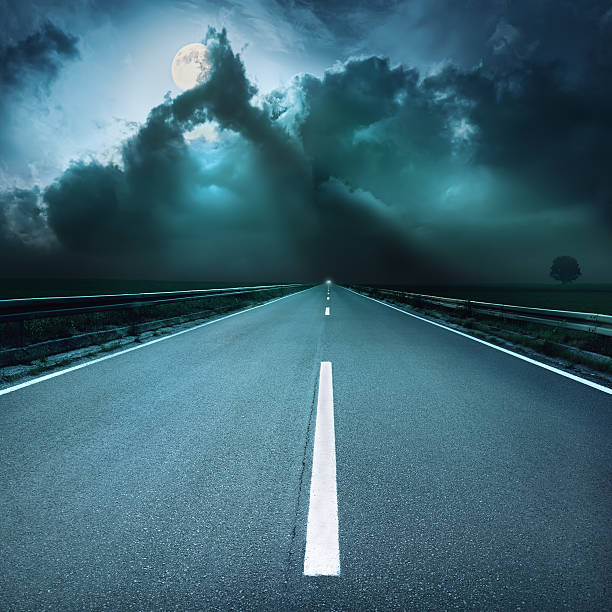 istock Driving on asphalt road towards  oncoming stormy night 452221821