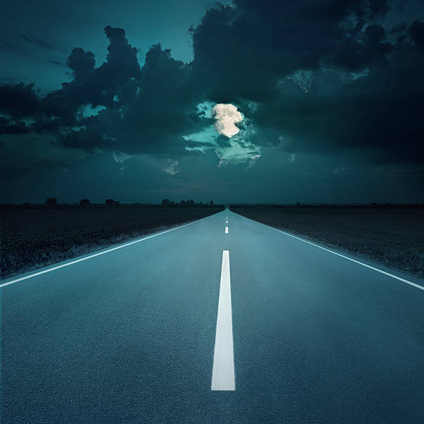 istock Night driving on an empty road to the moon 452221839