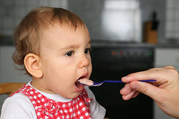 istock Mother giving baby something to eat 452222859