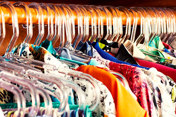 Closet Photo of a large groupe of casual clothes at hangers. clothes hanger rod stock pictures, royalty-free photos & images