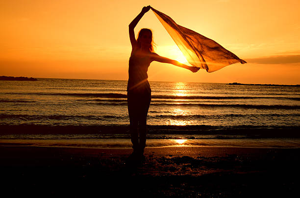 istock Woman dancing on the beach at sunrise 452231951