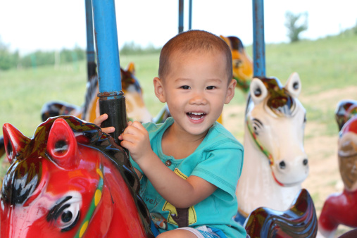 Boy on a merry-go-round, very happy