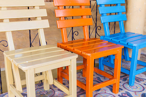 Three chairs Three chairs in brown room. triumvirate stock pictures, royalty-free photos & images