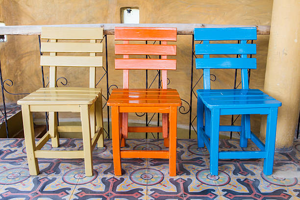 Three chairs Three chairs in brown room. triumvirate stock pictures, royalty-free photos & images