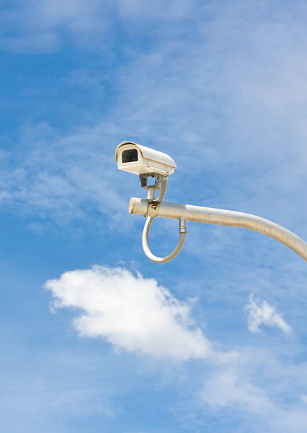 istock outdoor cctv camera against blue sky 452239059