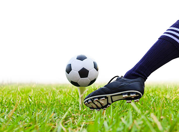 istock foot kicking soccer ball on golf tee isolated 452241749