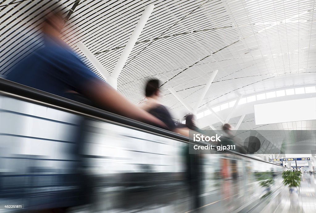 passenger passenger rushing through an escalator in airport terminal Adult Stock Photo