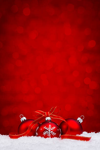 istock Red bauble withs snowflake decoration lying on snow 452255691