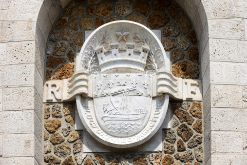 Barcelona, Spain - august 2022: Nameplate and Symbol of the Palau del lloctinent Courtyard, Headquarters of the State Archives and Crown of Aragon in the Gothic Neighborhood, Spain.