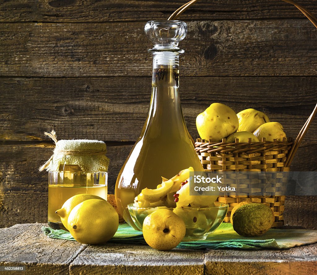 alcohol quince liqueur sliced fruit prepare wooden setting Tincture of quince and fruit on a wooden table Lemon - Fruit Stock Photo