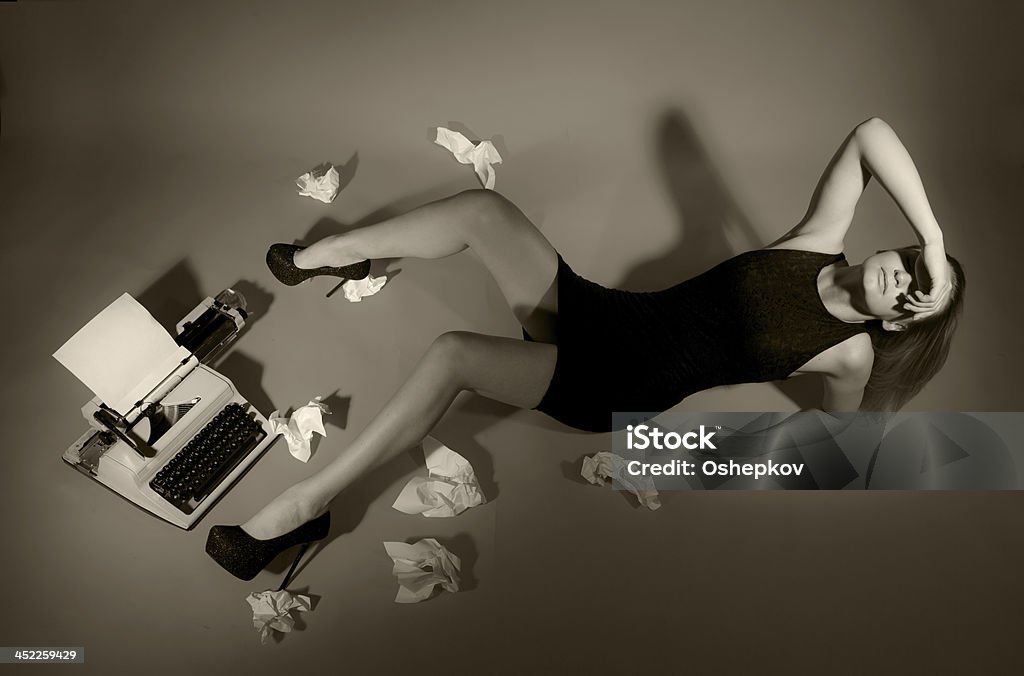 Beautiful girl lies at the typewriter. Beautiful girl lies at the typewriter. She disappointment. She has no inspiration. It can not work. Beauty Stock Photo