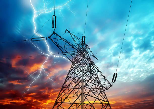 Electricity Towers Dramatic Image of Power Distribution Station with Lightning Striking Electricity Towers lightning tower stock pictures, royalty-free photos & images