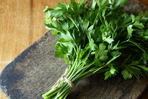 istock bunch of fresh parsley on an old chopping board 452263827