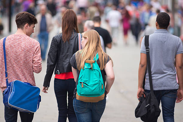 istock teenagers walking through a city centre 452266411