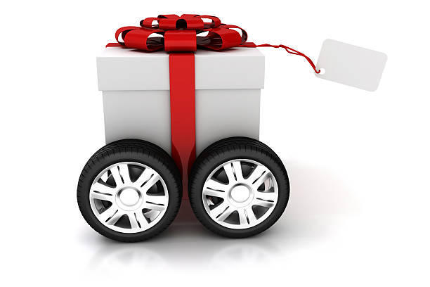 istock White gift box wrapped in red bow and carried on wheels 452268041