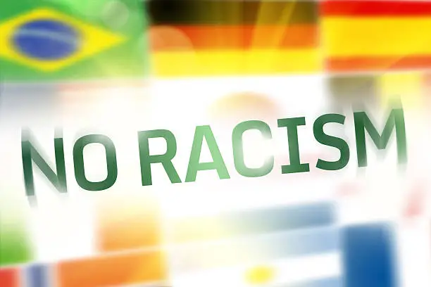 No Racism written on abstract national flags background.