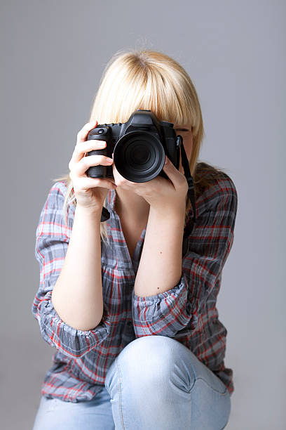 istock young female photographer 452269319