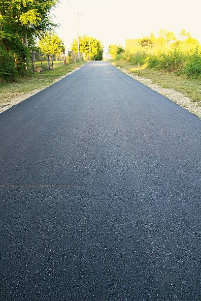 New asphalt in colony New asphalt road in colony. hard bituminous coal stock pictures, royalty-free photos & images