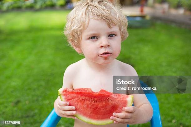 Adorabile Piccolo Ragazzo Bambino Con I Capelli Biondi Capelli Mangiare Anguria - Fotografie stock e altre immagini di 2-3 anni