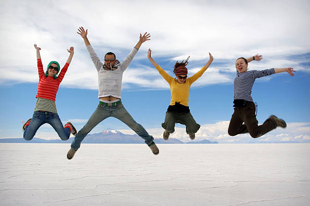 istock Happy friends jumping outdoor 452346083