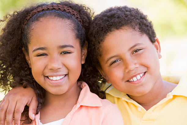 istock Brother and sister outdoors smiling 452351751