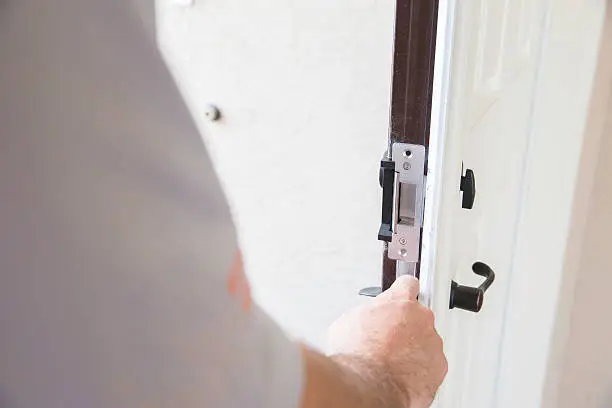 Construction: Contractor installing security lock.  rr
